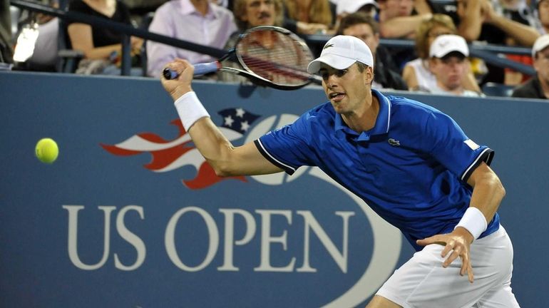 John Isner of USA runs for the ball against Gael...