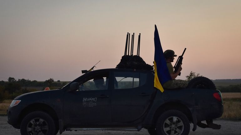 A soldier of Ukraine's 141st separate infantry brigade rides in...