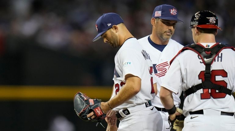 United States pitcher Nick Martinez, left, exits during the third...