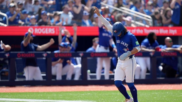 Toronto Blue Jays shortstop Bo Bichette (11) celebrates after scoring...