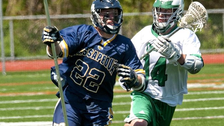 Farmingdale's Korey Hendrickson, right, drives down the field to defend...