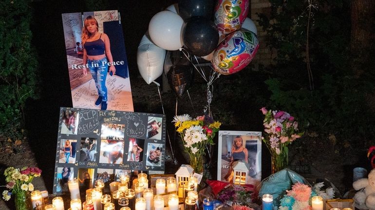 Candles and other mementos at a memorial in Huntington for Seikeya...