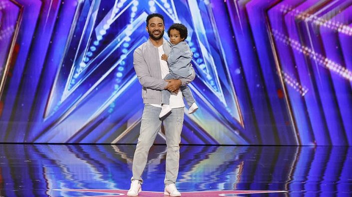 Proud dad Duane Defreitas holds his 2-year-old math whiz son, Devan,...