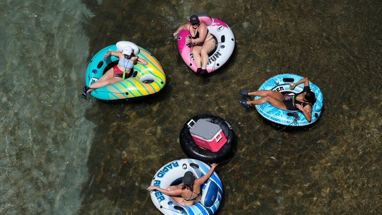 Tubers float the cool Comal River as temperatures in South...