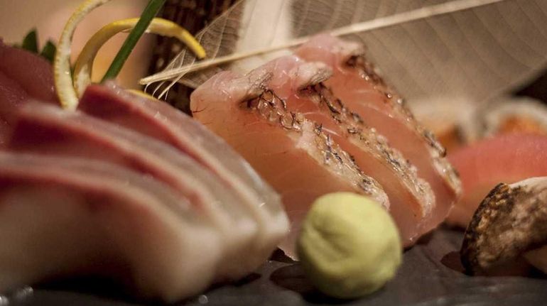 An artful platter of sushi and sashimi is served at...