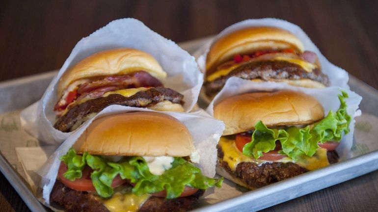 The juicy SmokeShack burger at Shake Shack is topped with...