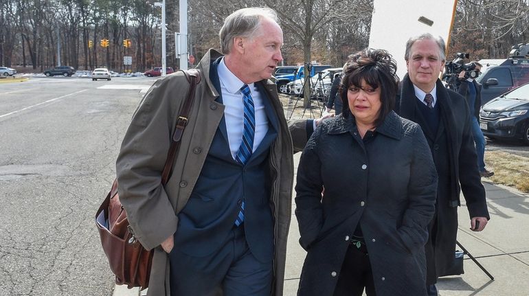 Attorney Kevin Keating, left, comforts Linda and Edward Mangano outside federal...