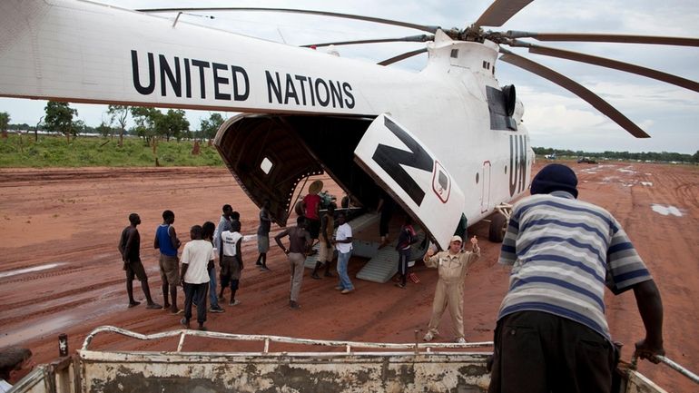 A World Food Programme (WFP) truck backs up to load...