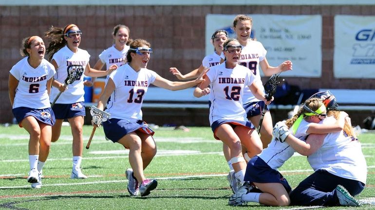 Manhasset players celebrate following the game against Victor during the...