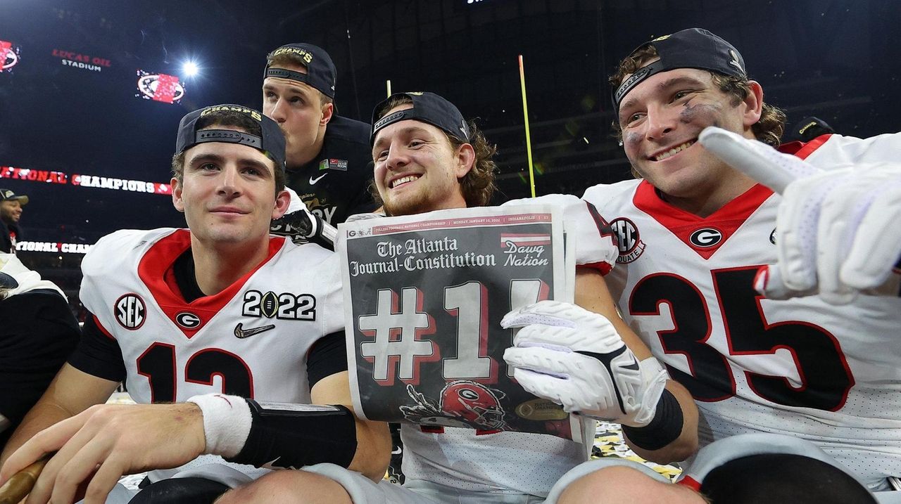 Georgia Bulldogs defensive lineman Jordan Davis (99) celebrating during the  trophy presentation of the 2022 CFP college football national championship  game at Lucas Oil Stadium, Monday, Jan. 10, 2022, in Indianapolis. Georgia