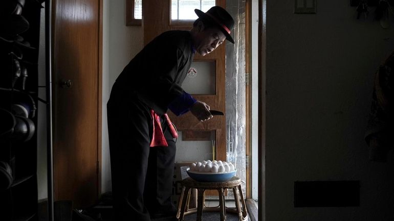 Nhia Neng Vang conducts a soul-calling ritual at his home...