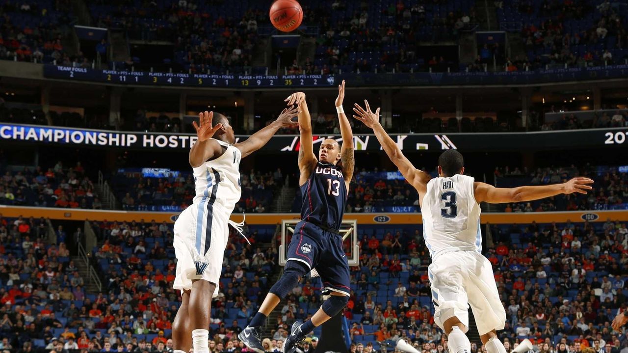 Connecticut's Shabazz Napier, right, is greeted by NBA