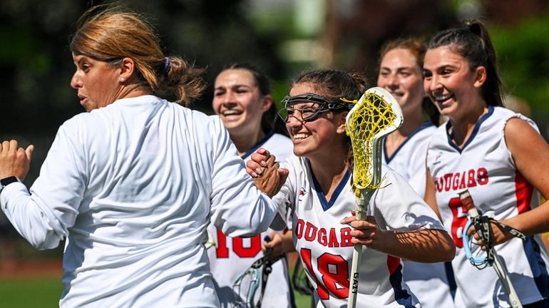 Sophia Virgilio of St. John the Baptist, center, approaches head coach Janine Pirone...