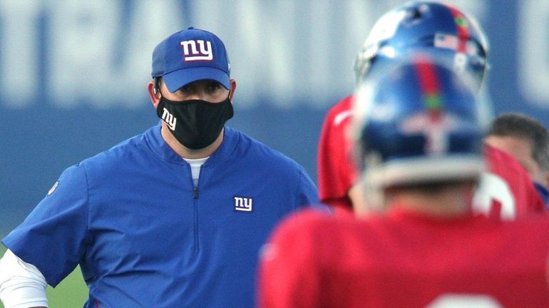 Giants head coach Joe Judge talks to the quarterbacks during...