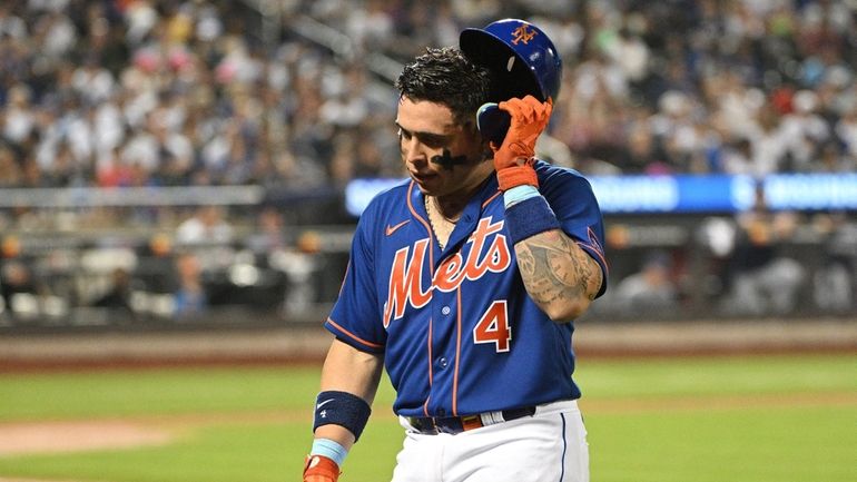 Mets' Francisco Alvarez returns to the dugout after he flied...