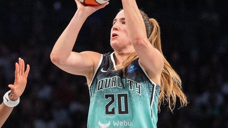 Liberty’s Sabrina Ionescu shoots over the defense of the Chicago Sky...