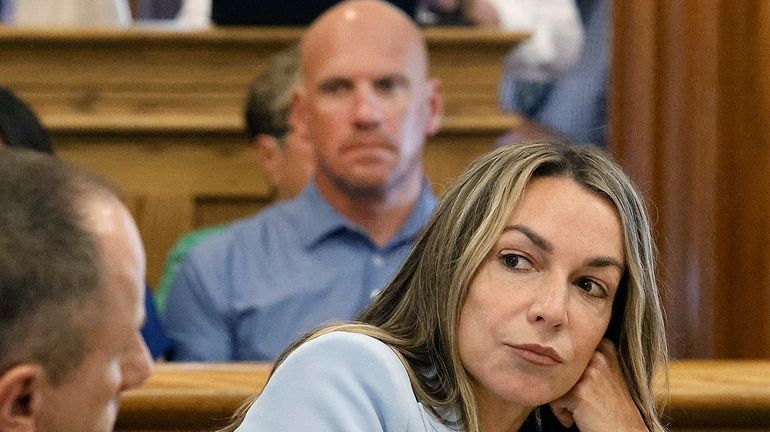 FILE — Karen Read listens to her attorney, Martin Weinberg,...