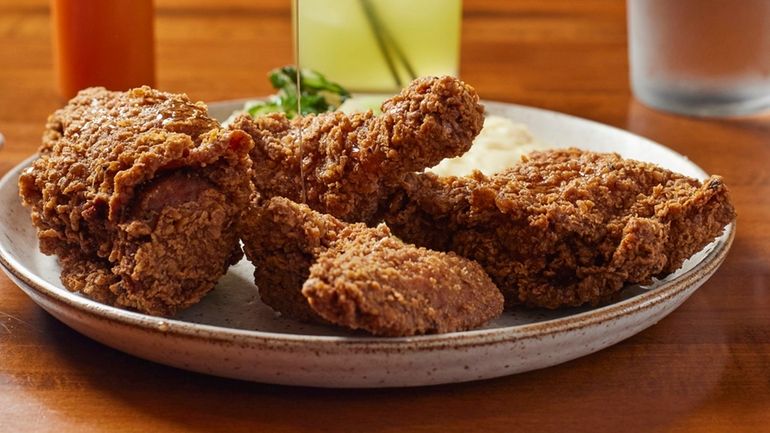 Fried chicken with mashed potatoes, bok choy and drizzled with...