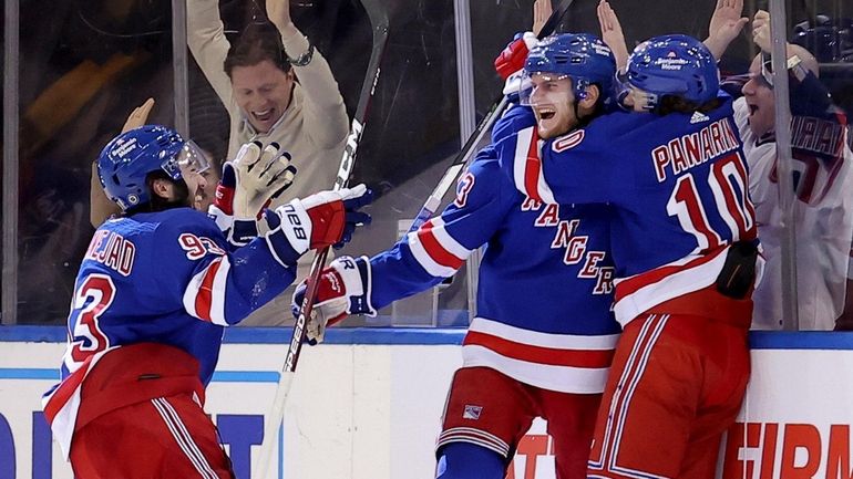 Rangers defenseman Adam Fox celebrates his game winning goal against...