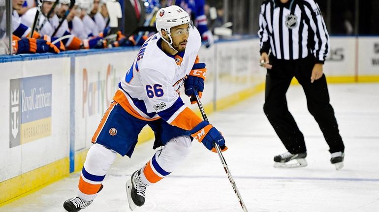 Josh Ho-Sang of the Islanders controls the puck against the...