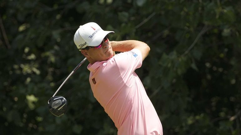 Zach Johnson hits his drive on the second hole during...