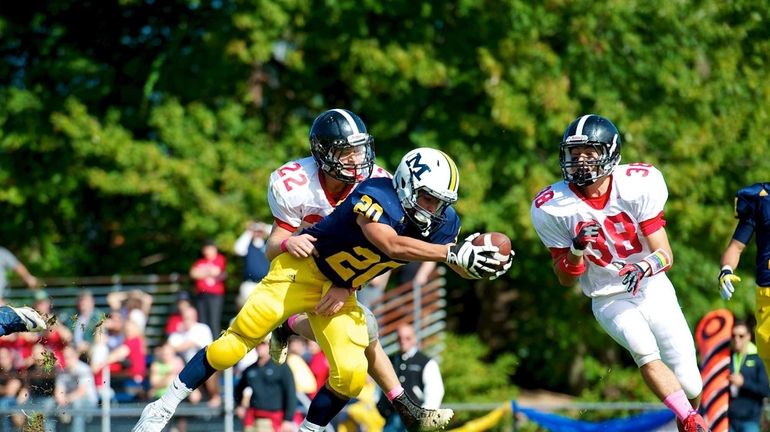 Massapequa running back Nick Capuana (no. 20) dives across the...