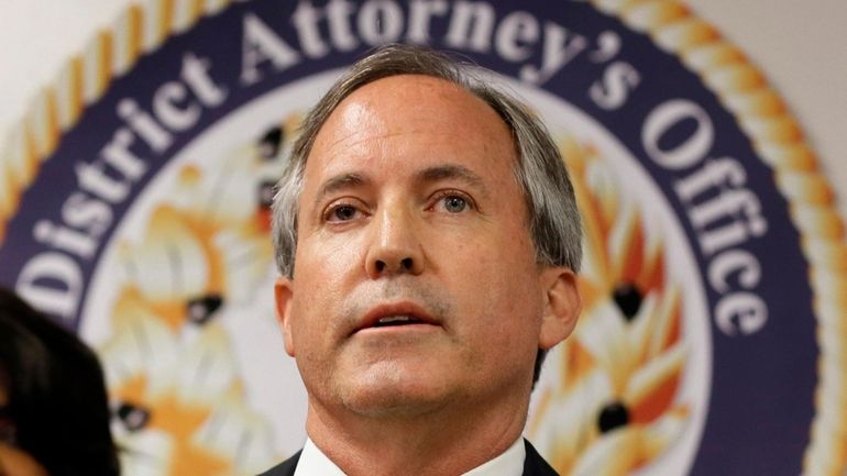 Texas Attorney General Ken Paxton speaks at a news conference...