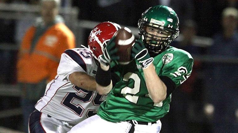 Farmingdale's Vinny Schultz makes a catch for a first down...