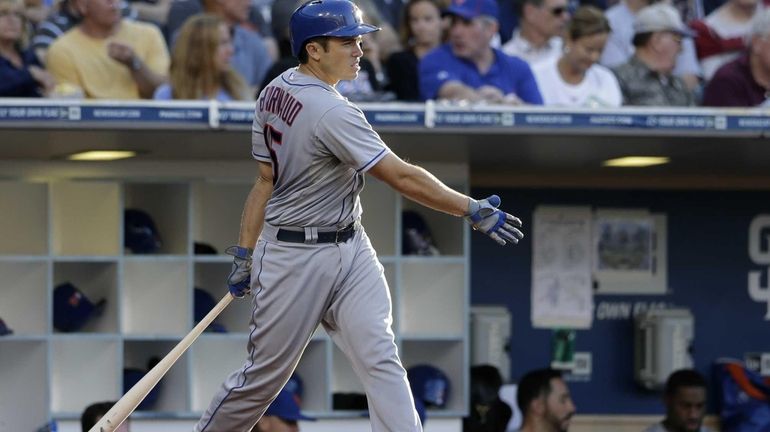 Mets Travis d'Arnaud warms up as he waits to bat...