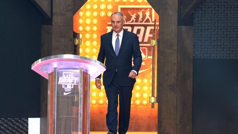 Major League Baseball Commissioner Rob Manfred walks up to the...