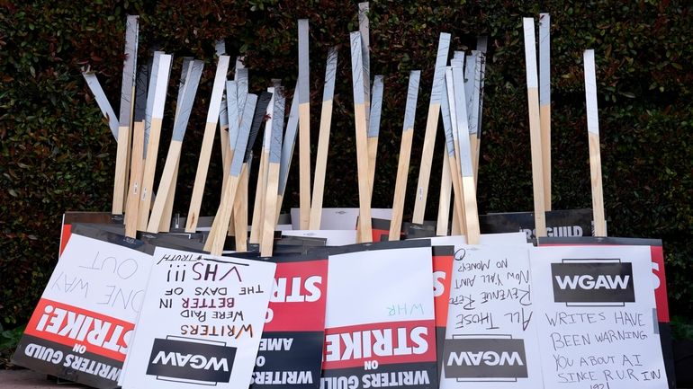 Placards are gathered together at the close of a picket...