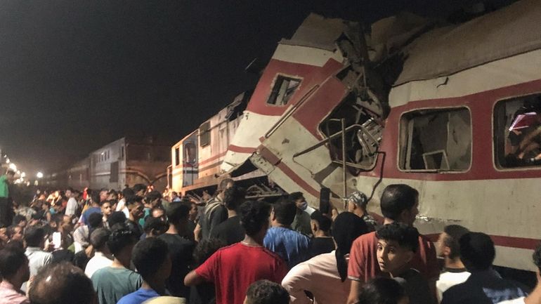 People surround two passenger trains which collided in Egypt's Nile...