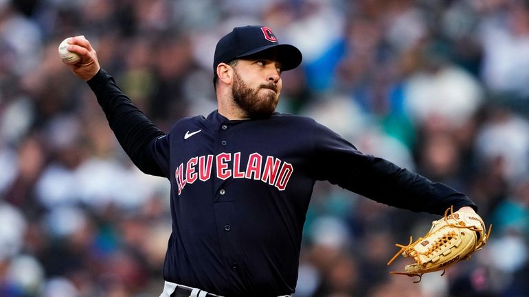 Cleveland Guardians starting pitcher Aaron Civale throws to a Seattle...