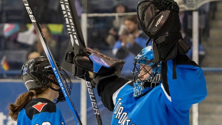 Toronto goaltender Kristen Campbell (50) celebrates clinching first place in...