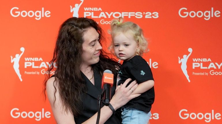 New York Liberty forward Breanna Stewart holds her daughter Ruby...