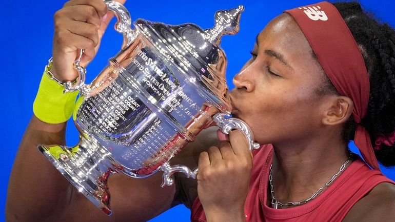 Coco Gauff, of the United States, poses for photographs after...