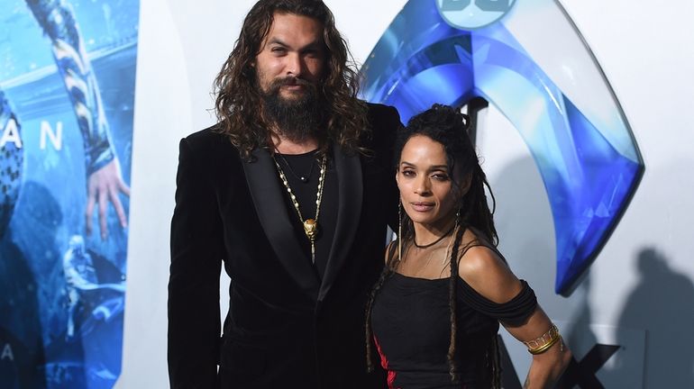 Jason Momoa, left, and Lisa Bonet, right, arrive at the...