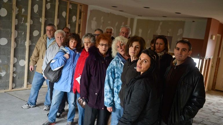 Homeowners from the Anchorage co-op complex in Freeport gather inside...