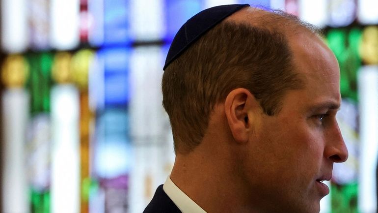 Britain's Prince William, the Prince of Wales wears a kippah...