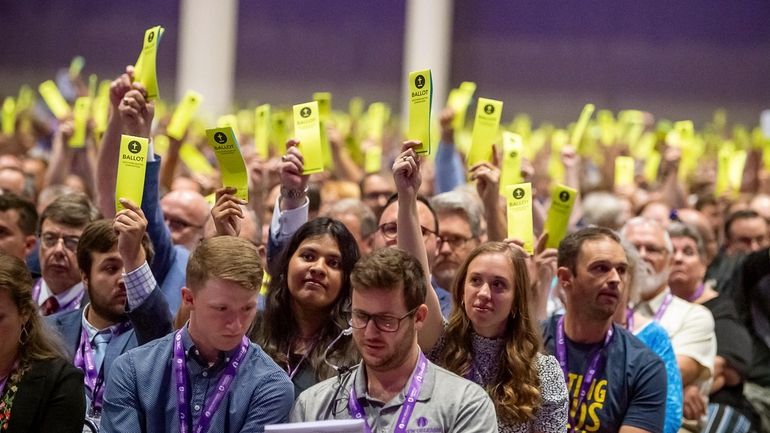 Delegates hold up their ballots at the Southern Baptist Convention...