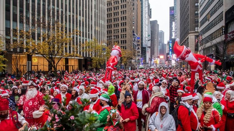 Crowds celebrate the start of the 2021 SantaCon in Manhattan.