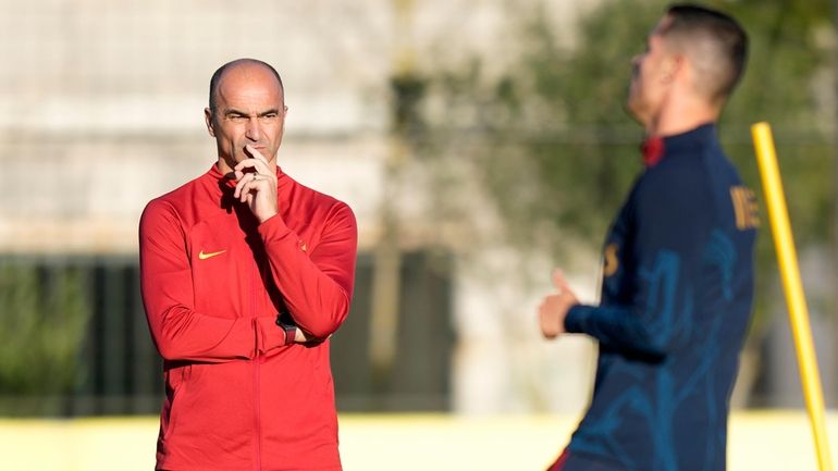 Portugal coach Roberto Martinez watches Cristiano Ronaldo, right, during a...