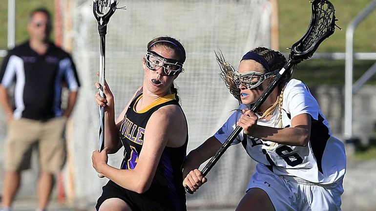 Sayville's Kaitlyn Wandelt drives against Eastport-South Manor's Delaney Schappert in...