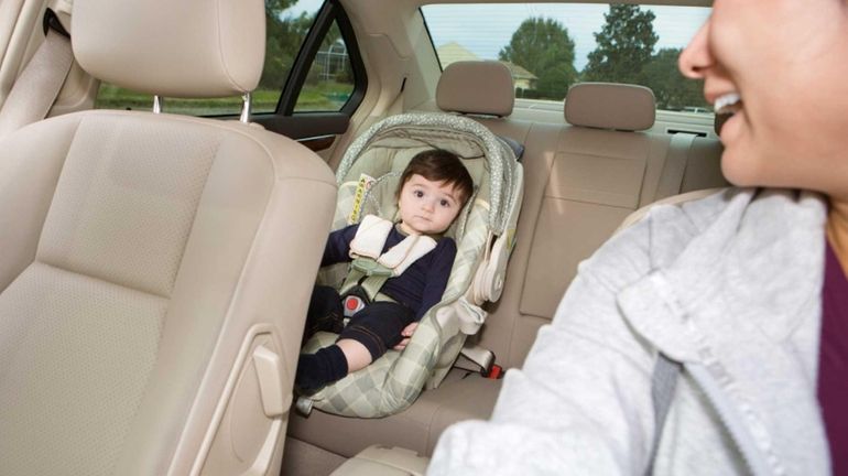 Baby in car seat while his mom is driving.