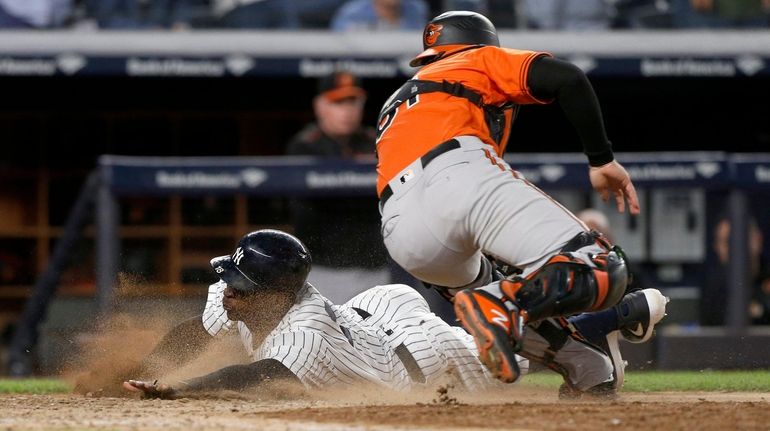 Didi Gregorius #18 of the New York Yankees score under...