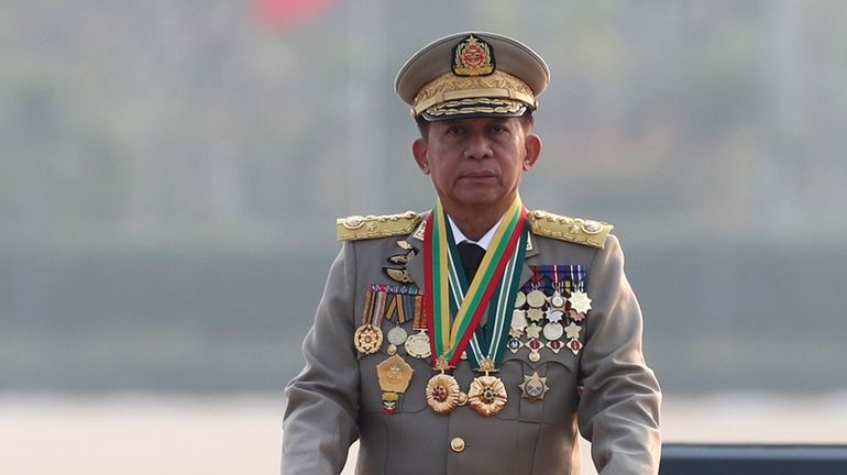 Gen. Min Aung Hlaing inspects officers during a parade to...