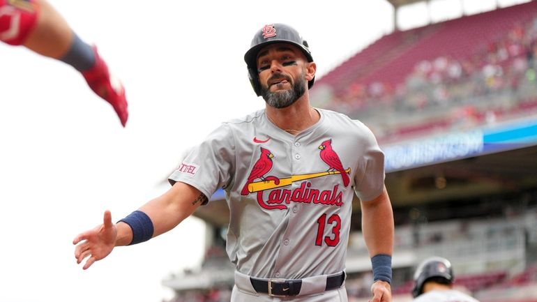 St. Louis Cardinals' Matt Carpenter (13) celebrates with teammates after...