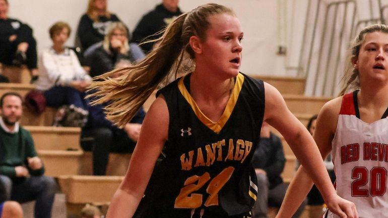 Wantagh's Kayla Mannix circles the basket with Lia Villari of...