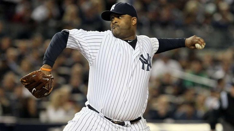 CC Sabathia #52 of the New York Yankees pitches in...