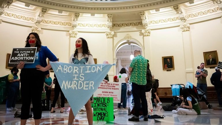 Sarah Zarr, left, from Students for Life of America, and...